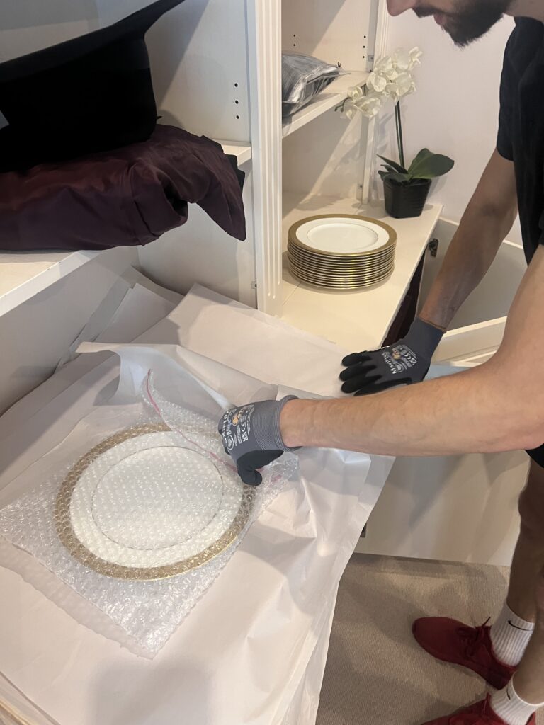 Careful packing of china and fragile kitchen items by Swift Removals Ltd