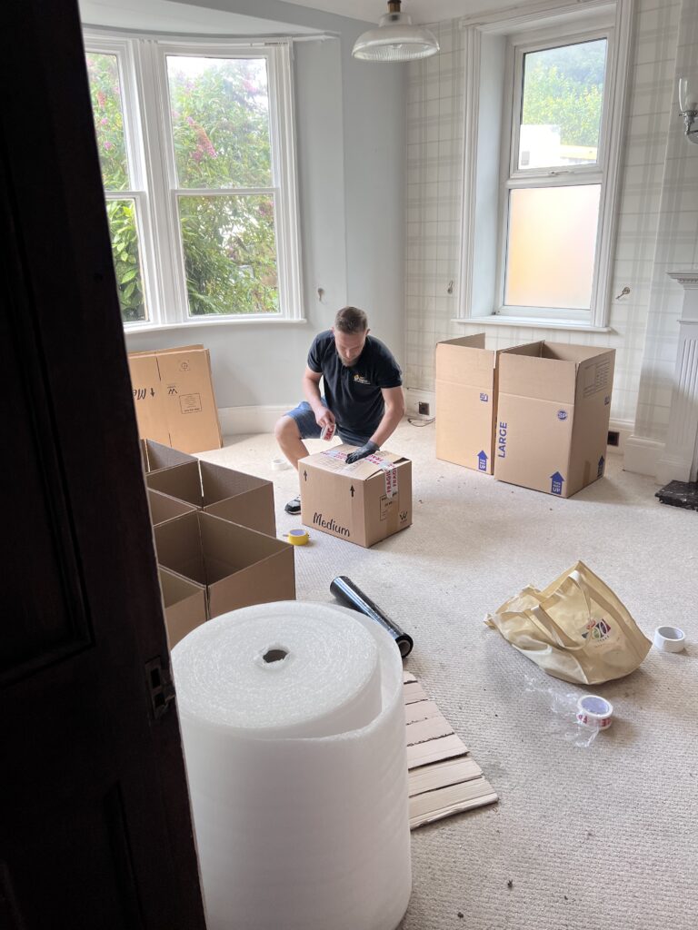Professional packing service by Swift Removals preparing boxes for a house move in West Yorkshire